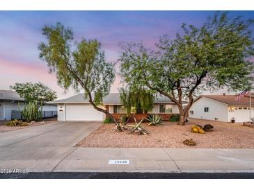 Ranch style home with a landscaped front yard and two-car garage at 13438 W Prospect Dr, Sun City West, AZ 85375