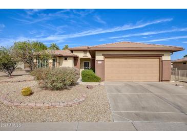 Single-story home with a two-car garage and desert landscaping at 16828 W Palisade Trail Ln, Surprise, AZ 85387