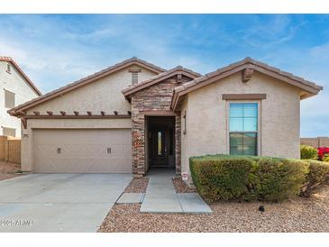 One-story home with stone accents and a two-car garage at 29715 N 119Th Ln, Peoria, AZ 85383