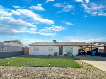 Updated single-story home with a landscaped lawn and carport at 4121 W Alta Vista Rd, Phoenix, AZ 85041