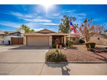 Ranch-style home with a two-car garage and landscaped front yard at 1511 W El Monte Pl, Chandler, AZ 85224