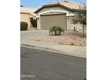 Single-story house with attached garage and desert landscaping at 15350 W Mauna Loa Ln, Surprise, AZ 85379