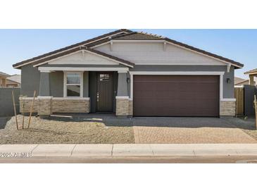 Charming single-Gathering home with a two-car garage and low-maintenance desert landscaping at 17755 W Elm St, Goodyear, AZ 85395