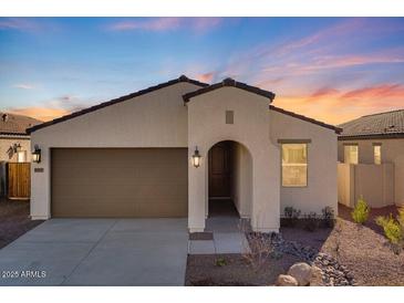 Single-story home with a two-car garage and desert landscaping at 18111 W Hiddenview Dr, Goodyear, AZ 85338