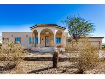 Spanish style home with arched entryway and two-car garage at 27511 N 33Rd Ave, Phoenix, AZ 85083