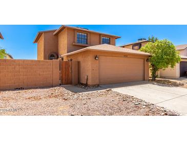 Two-story house with tan exterior, attached garage, and small front yard at 3745 W Carol Ann Way, Phoenix, AZ 85053