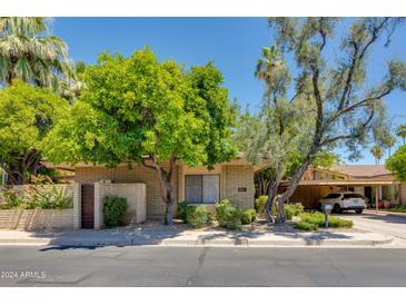 Cute mid-century home with landscaped front yard and driveway at 4525 N 66Th St # 34, Scottsdale, AZ 85251