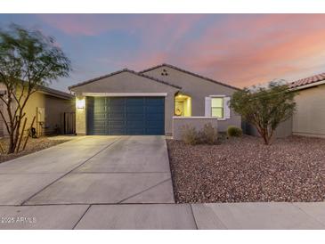 New construction home with two-car garage and landscaped yard at 5644 W Jackalope Ln, Laveen, AZ 85339