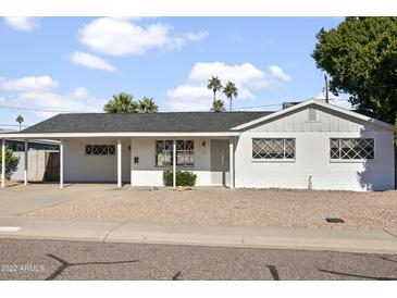 White single story home with carport and landscaped yard at 6732 E Culver St, Scottsdale, AZ 85257