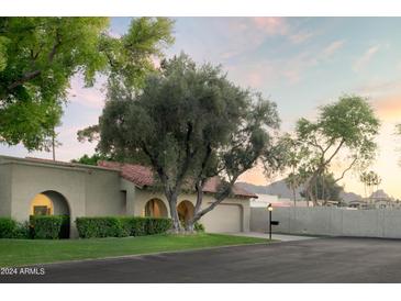 Charming ranch home with mature landscaping and a two-car garage at 7301 E Claremont St, Scottsdale, AZ 85250