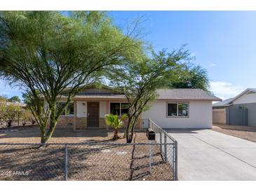 Cute single story home with a spacious front yard and chain link fence at 899 E Flint St, Chandler, AZ 85225