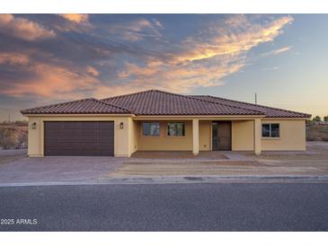 New single-story home with a two-car garage and desert landscaping at 125 Ironwood Pl, Wickenburg, AZ 85390