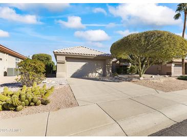 Single-story home with a two-car garage and desert landscaping at 14408 W Corral Dr, Sun City West, AZ 85375