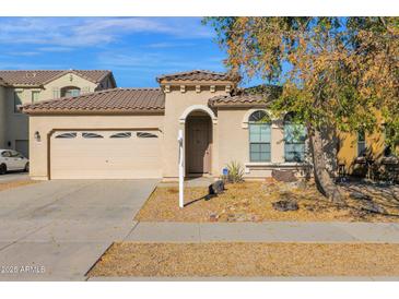 One-story house with a two-car garage and desert landscaping at 15466 W Laurel Ln, Surprise, AZ 85379