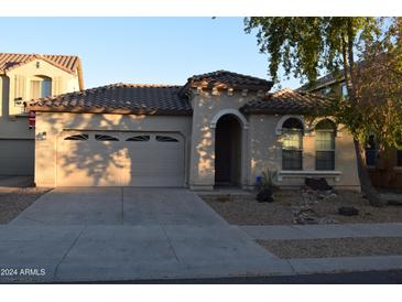 One-story home with attached garage and desert landscaping at 15466 W Laurel Ln, Surprise, AZ 85379