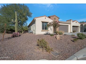 Single-story home with desert landscaping and a two-car garage at 16464 W Piccadilly Rd, Goodyear, AZ 85395