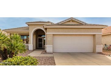 Tan one-story house with a two-car garage and desert landscaping at 18109 W Skyline Dr, Surprise, AZ 85374