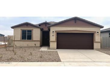 Single-story home with brown garage door and landscaping at 19021 W Rose Ln, Waddell, AZ 85355