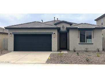 New single-story home with a two-car garage and attractive landscaping at 19027 W Rose Ln, Waddell, AZ 85355