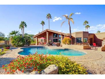 Inviting backyard oasis featuring a sparkling pool and relaxing patio area at 19035 E Tonto Trl, Rio Verde, AZ 85263