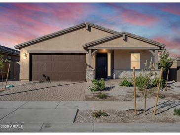 New single-story home with a brown garage door and stone accents at 24 S 175Th Ave, Goodyear, AZ 85338