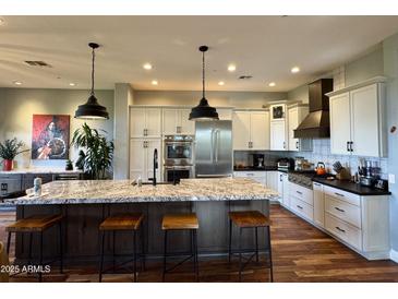 Gourmet kitchen boasts granite counters, stainless steel appliances, and ample cabinetry at 28414 N 101St Pl, Scottsdale, AZ 85262