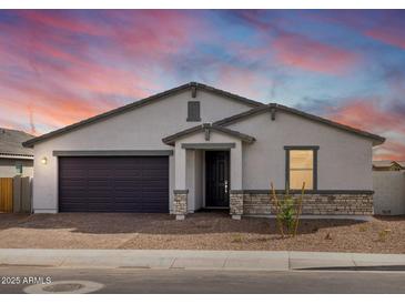 Charming single-story home featuring a two-car garage, neutral paint, and low-maintenance desert landscaping at 35581 N Thicket Way, San Tan Valley, AZ 85144