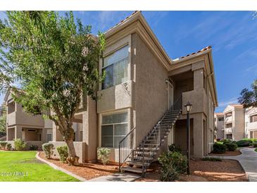 Exterior view of a two-story condo with a staircase and landscaping at 3830 E Lakewood Pkwy # 1114, Phoenix, AZ 85048