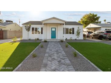 Newly renovated home with artificial turf and a herringbone walkway at 3850 N 12Th Ave, Phoenix, AZ 85013