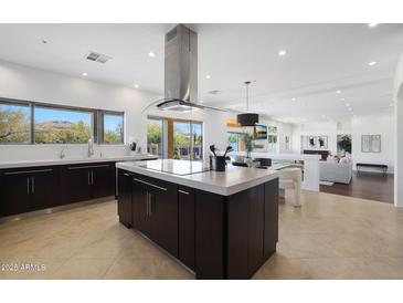 Spacious kitchen boasts modern island, stainless steel appliances, and ample counter space at 7687 E Wing Shadow Rd, Scottsdale, AZ 85255