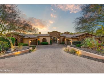 Stunning stone & stucco home with a large driveway and mature landscaping at 9108 N Fireridge Trl, Fountain Hills, AZ 85268