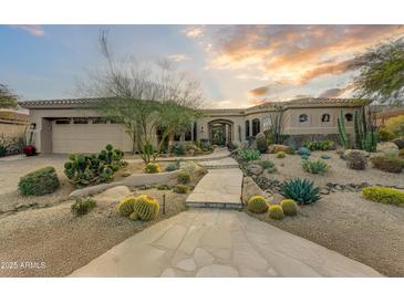 Stunning desert landscape surrounds this single-story home with a large three-car garage at 9697 E Preserve Way, Scottsdale, AZ 85262