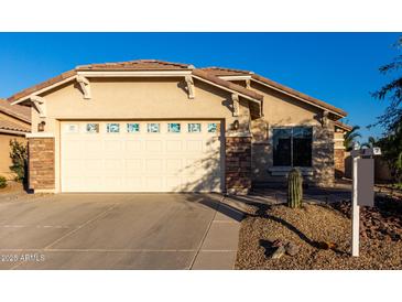 Single-story home with a two-car garage and desert landscaping at 1127 S 165Th Dr, Goodyear, AZ 85338