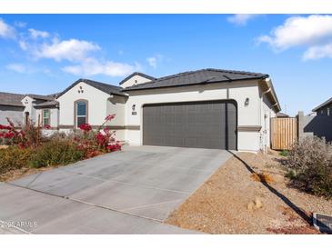 New single-story home with a 2-car garage and desert landscaping at 1130 W Avalon Canyon Dr, Casa Grande, AZ 85122