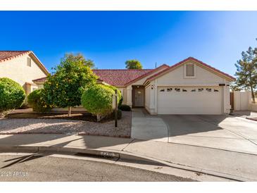 Single-story home with red tile roof, two-car garage, and mature landscaping at 1201 E Campbell Ave, Gilbert, AZ 85234