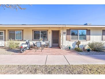 Inviting condo exterior featuring a patio and landscaping at 13609 N Newcastle Dr, Sun City, AZ 85351