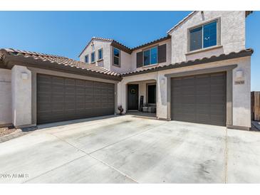 Two-story home with a three-car garage and landscaped front yard at 19690 W Marshall Ave, Litchfield Park, AZ 85340