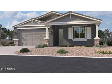 One-story home with gray siding, stone accents, and a two-car garage at 22851 E Lords Way, Queen Creek, AZ 85142