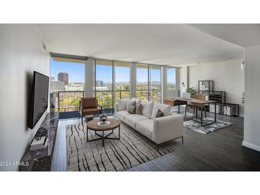 Bright living room with city views and modern furniture at 2323 N Central Ave # 906, Phoenix, AZ 85004