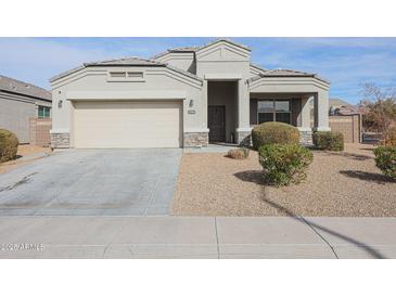 Single-story house with a two-car garage and well-manicured landscaping at 29362 W Weldon Ave, Buckeye, AZ 85396