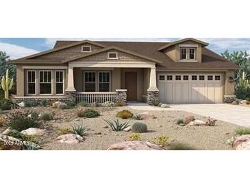 Craftsman style home with attractive stone accents and desert landscaping at 32496 N 135Th Dr, Peoria, AZ 85383