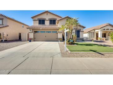 Two-story house with a two-car garage and landscaped front yard at 3610 N 106Th Ave, Avondale, AZ 85392