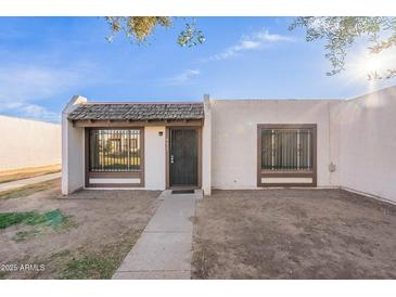 Inviting stucco home with a tiled walkway and a well-maintained front yard at 4622 W Desert Crest Dr, Glendale, AZ 85301