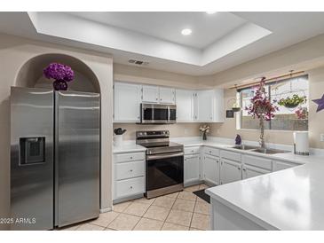 Modern kitchen with stainless steel appliances and white cabinetry at 5018 E Siesta Dr # 3, Phoenix, AZ 85044