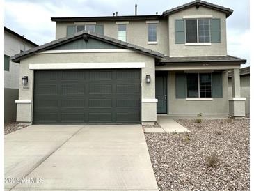 Two-story home with a two-car garage and stone accents at 5018 W Walatowa St, Laveen, AZ 85339