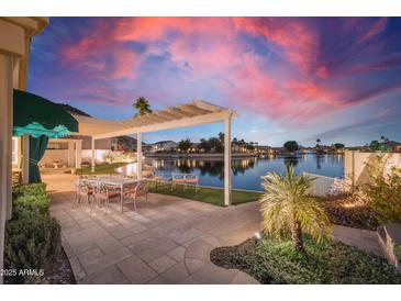 Lakefront patio with pergola, outdoor furniture, and serene views at 5287 W Quail Ave, Glendale, AZ 85308