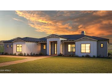 Stunning modern farmhouse exterior at sunset at 604 E Amber Sun Dr, Phoenix, AZ 85085