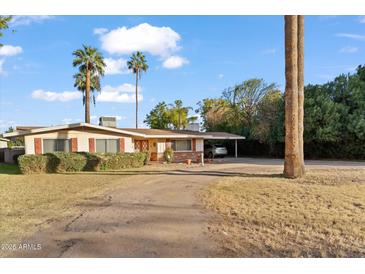 Ranch style home with carport and mature landscaping at 7329 N 16Th Ave, Phoenix, AZ 85021