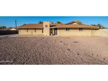 Ranch style home with a large gravel yard at 7736 W Acoma Dr, Peoria, AZ 85381