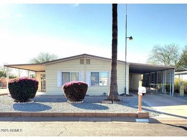 Single story home with carport and landscaped yard at 9655 E Edgewood Ave, Mesa, AZ 85208